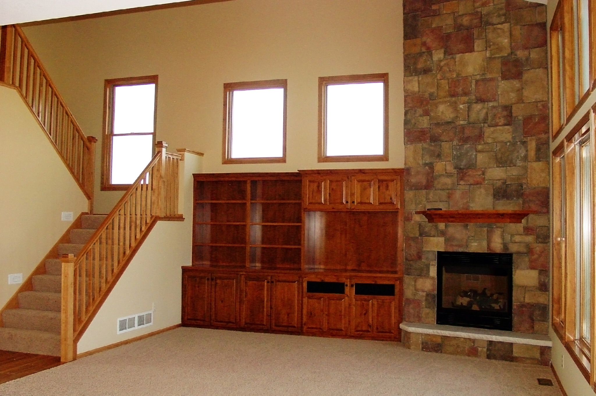 Living room with built-ins and stone fireplace