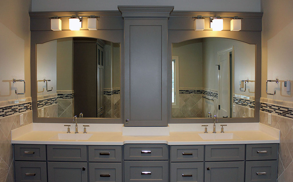Master bath with painted poplar cabinets, tile backsplash, arched mirror frames