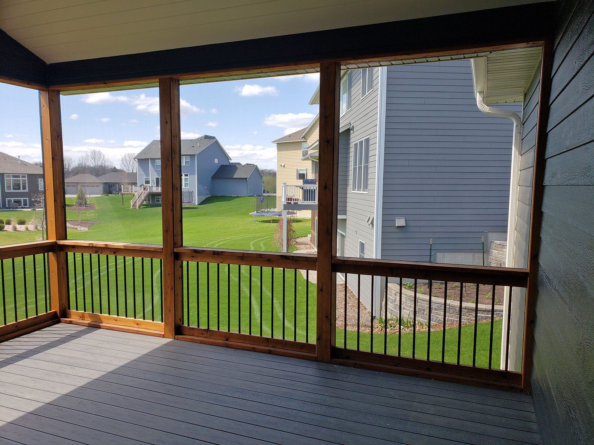 Screen porch with TimberTech composite decking with metal balusters and railing