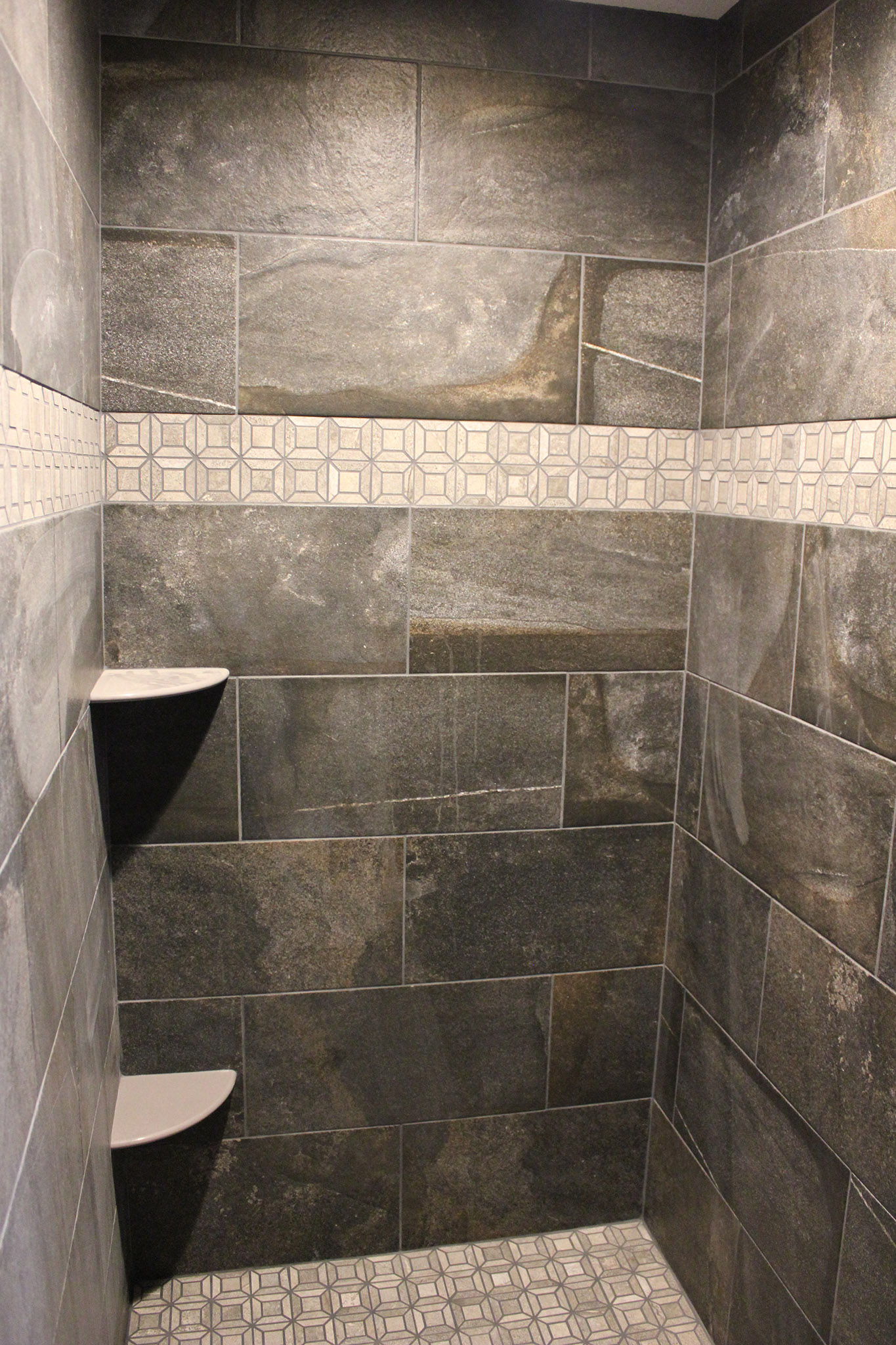 Master bath walk-in ceramic tile shower with mosaic border and floor and corner shelves